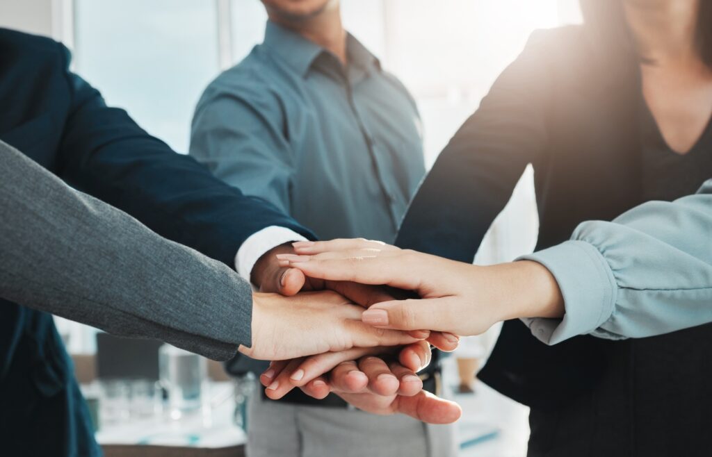 Collaboration, partnership and hands of business people in support of vision, growth and training o